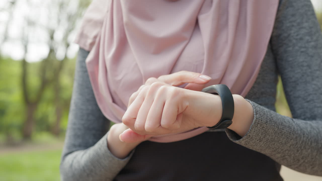 Woman Checking Smartwatch in Park