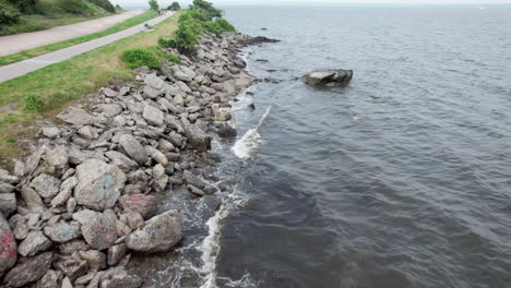 Aerial-video-of-waves-against-coastal-rocks,-Rocky-Point-RI