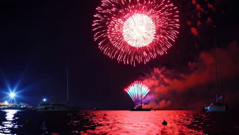 fireworks over the water with boats