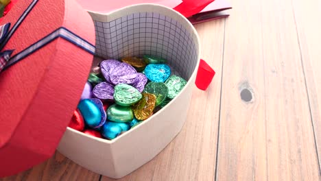 heart-shaped gift box filled with colorful chocolates