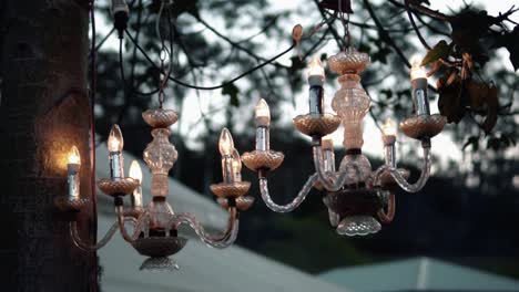 hanging candelabra outdoor for wedding decoration at sunset - low angle shot