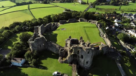 historic wales landmark denbigh castle medieval old hill monument ruin tourist attraction aerial view right top down orbit