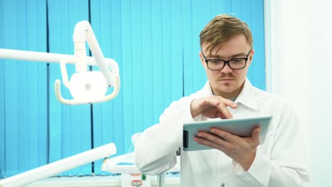 dentist using a tablet in a dental office