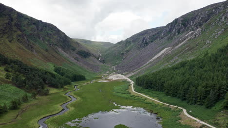 Aerial-Panning-Shot-of-Glendalough-Upper-Lake-in-Wicklow-Mountains-National-Park-in-Ireland