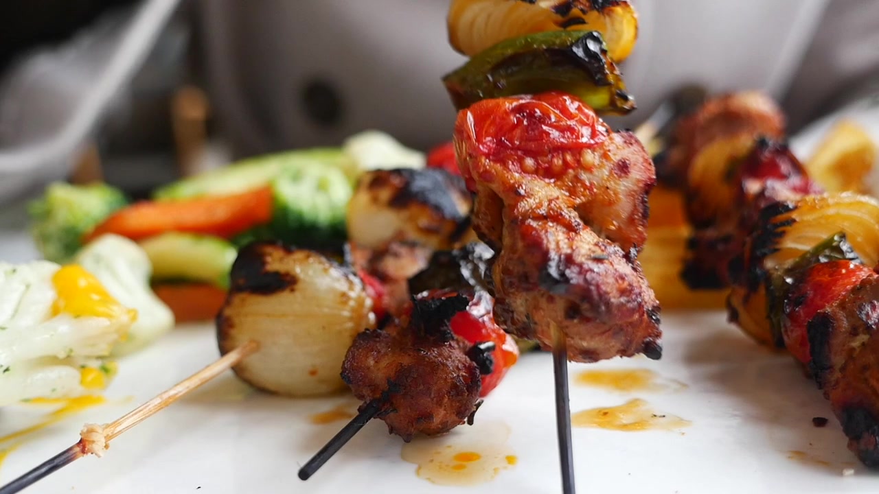 Primo piano di deliziosi spiedini di carne e verdure grigliati serviti