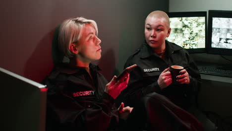 safety guards talking and using a smartphone in a room