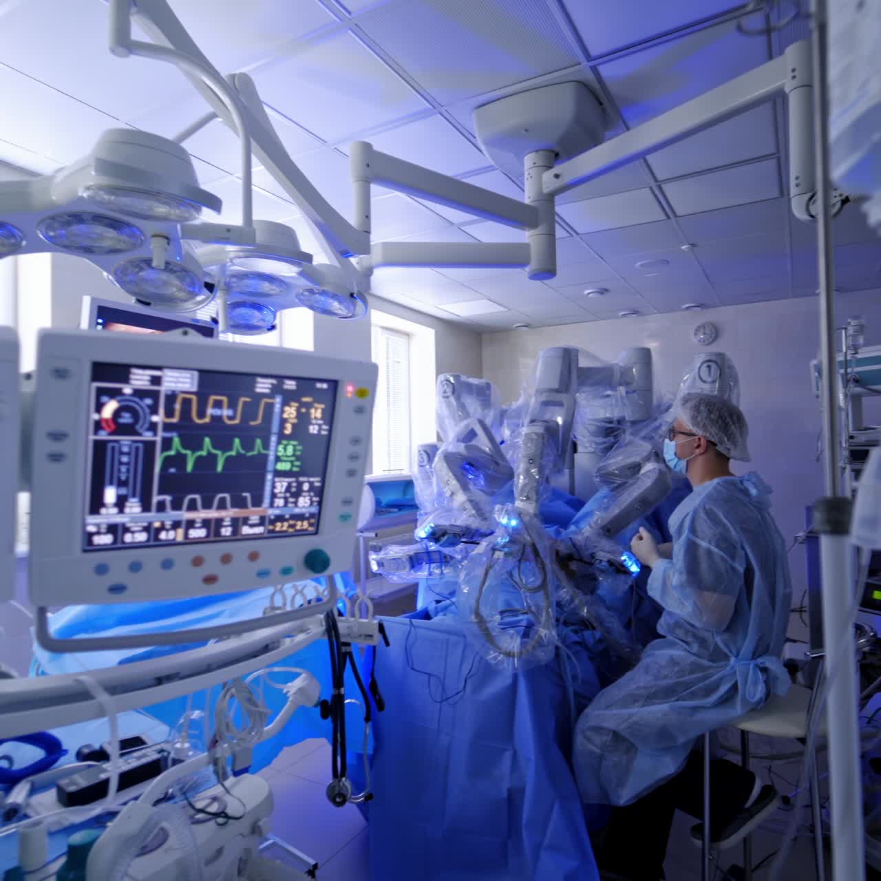 Robotic surgery with modern medical equipment. Professional doctor controls the work of da vinci system on the modern operating room background.
