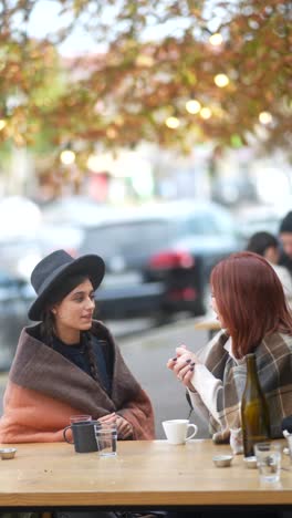 two women relaxing at an outdoor cafe