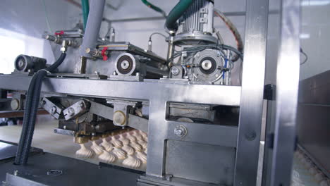 complicated mechanism moving to produce marshmallow desserts. automated line at manufacturing sweets.