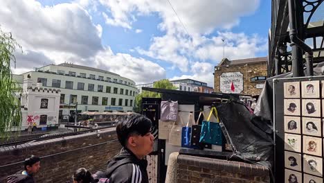 people walking by market stalls in camden town