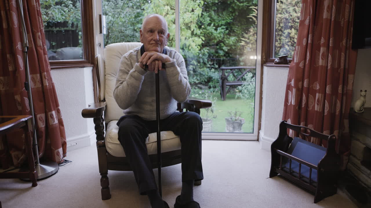 Elderly Man Relaxing in Armchair at Home