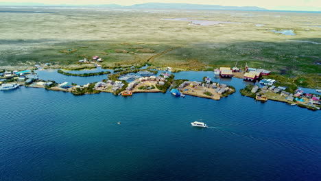 Aerial-pan-across-coastline-of-Uros-Island-floating-homes-on-Lake-Titicaca