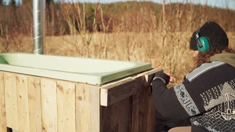 Man-Putting-Woods-To-Support-His-DIY-Hot-Tub---Close-Up