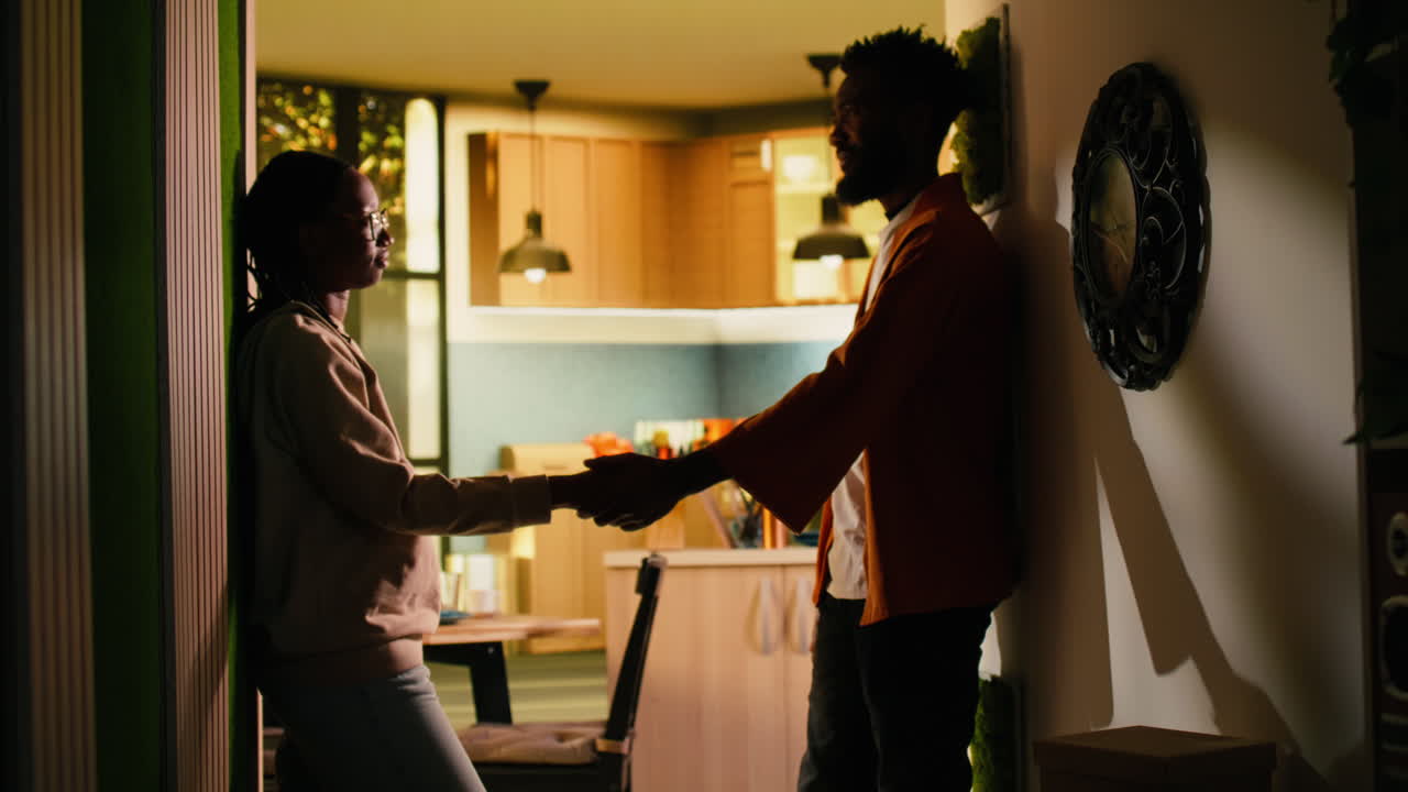 African American couple making peace after fight gently holding hands