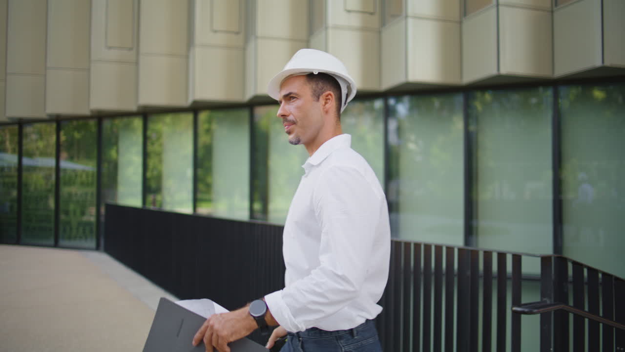 Confident engineer talking walkie-talkie walking district closeup. Man working