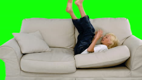 Young-boy-jumping-on-the-sofa-on-green-screen