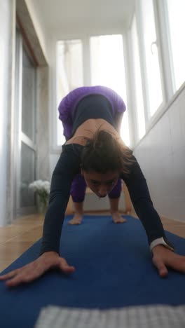 woman doing yoga on a balcony