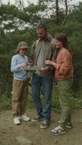 family hiking in the forest with a map
