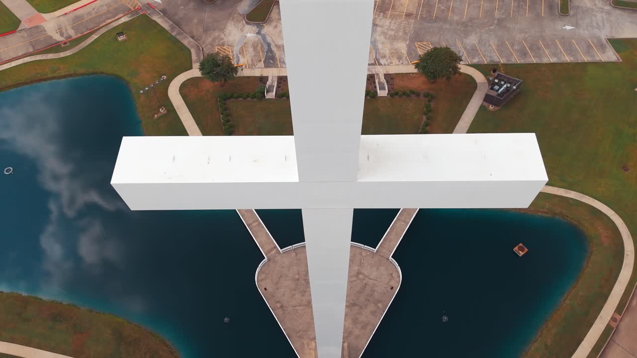 Aerial View of a Large White Cross at a Church