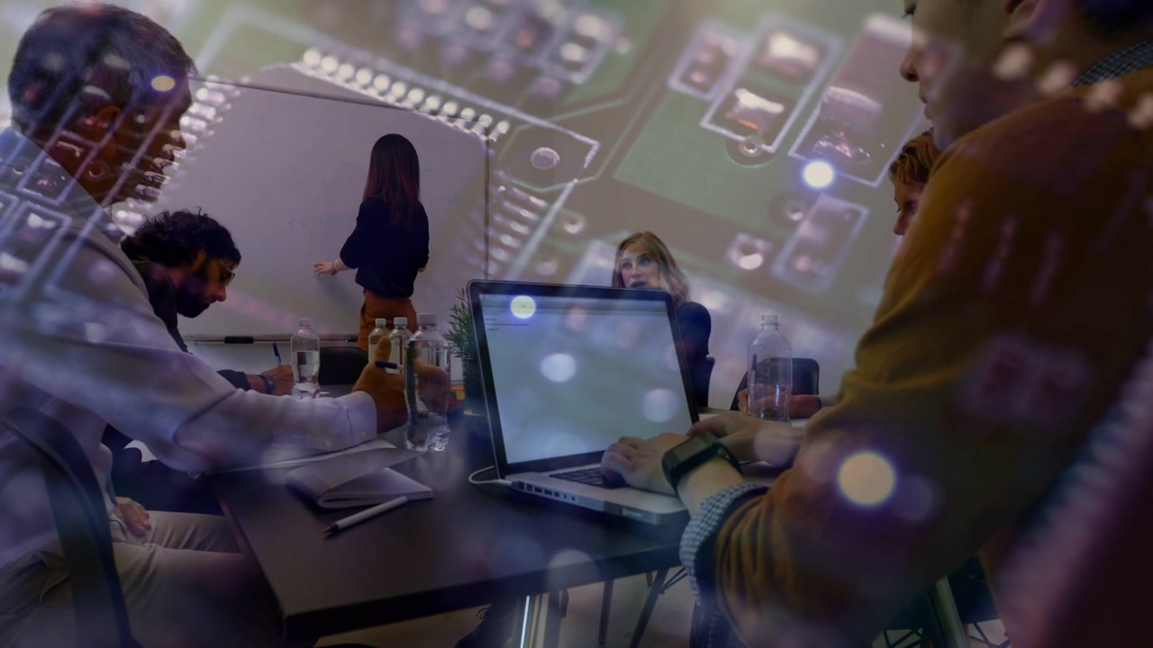 Presenter starting whiteboard notes tech team typing on laptop planning circuit overlay compositing