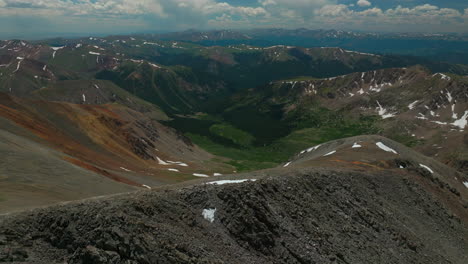 aerial cinematic drone early morning hiking trail grays to torreys 14er peaks looking at breckenridge colorado stunning landscape view mid summer green beautiful forward movement over ridge