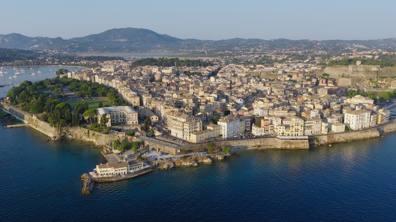 Aerial pullback shot of Old Corfu town on Ionian sea