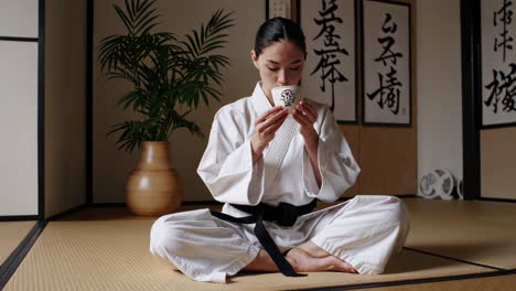 karate woman drinking tea