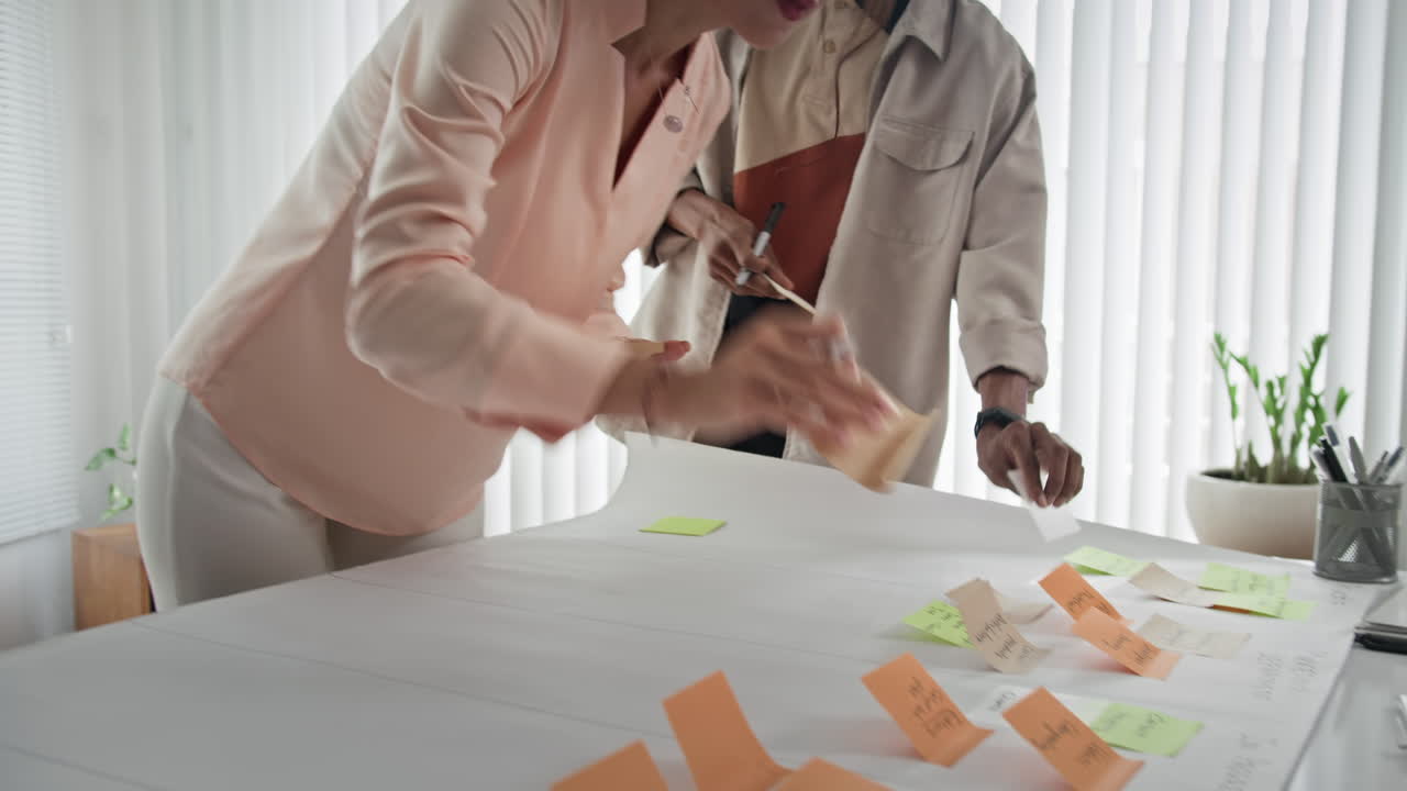 Three Marketers Having Brainstorming Discussion on Project at Office