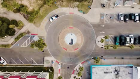 drone of tybee island round-about with light house and moving vehicle