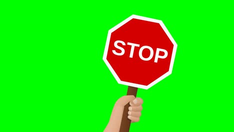 a hand holds up a stop sign on green background