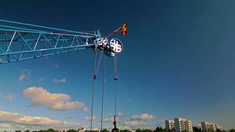 the load block and pulley system of main boom tip sheave on the end of the jib of a blue luffing construction crane