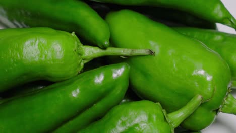 closeup pan left of green anaheim peppers, directly above