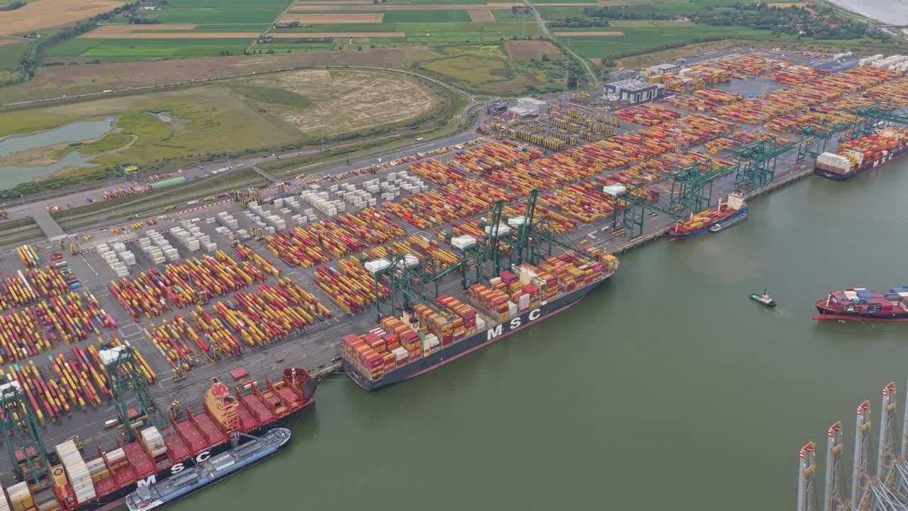 Aerial wide shot of shipping dock with cranes and containers, Belgium