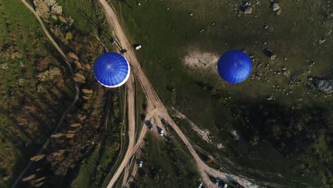 hot air balloons over a countryside landscape