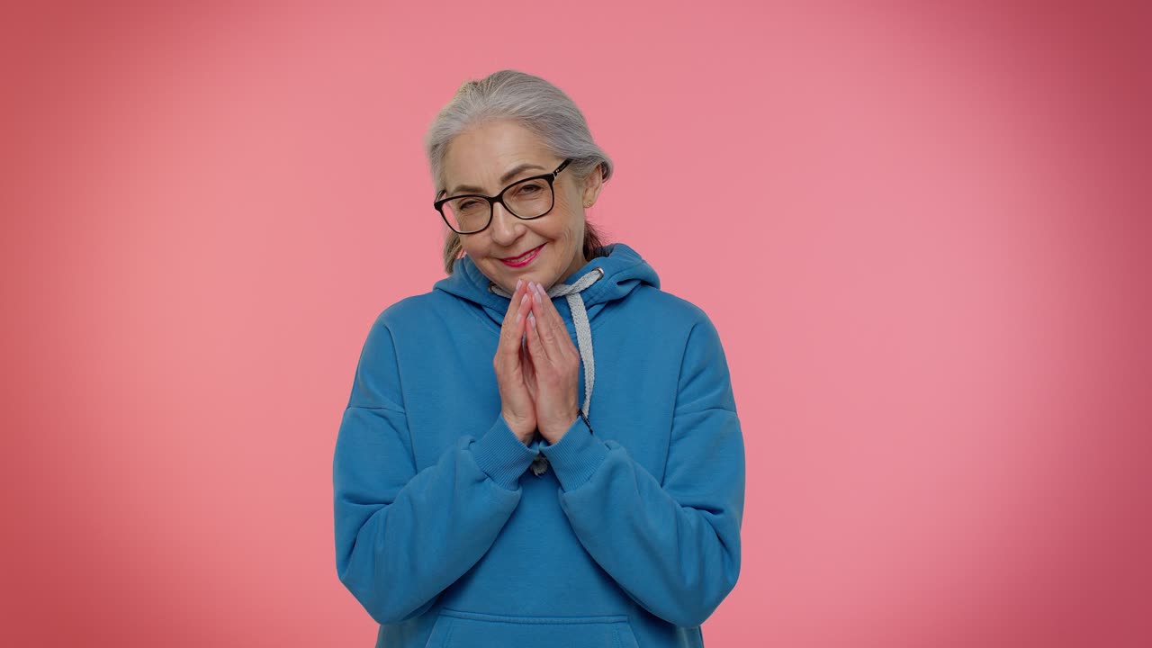 Sneaky mature grandmother woman thinking over devious villain idea, cunning cheats, jokes and pranks