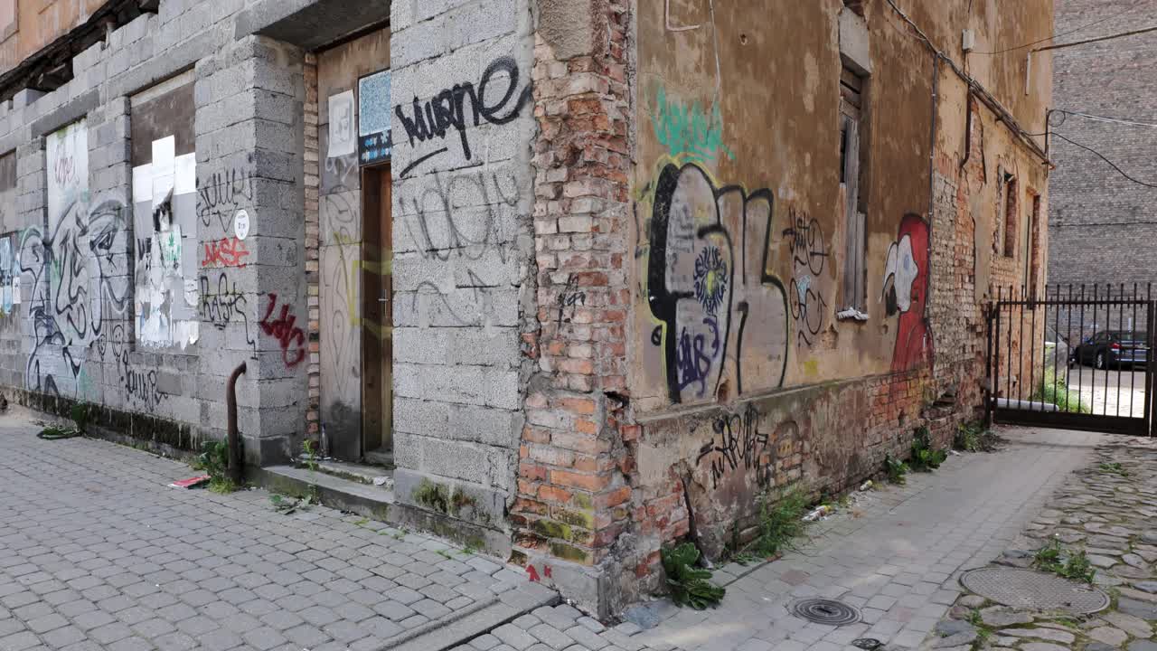 Worn bricks, broken windows reflect urban decay and neglect in central Riga zone