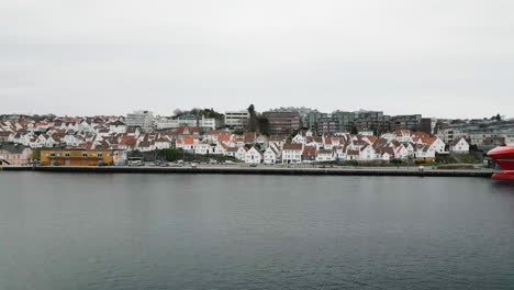 White-painted-wooden-houses-on-waterfront-of-old-Stavanger---aerial-establisher