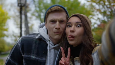 Portrait-of-cheerful-young-lovers-taking-selfie-on-smartphone-.Happy-couple.