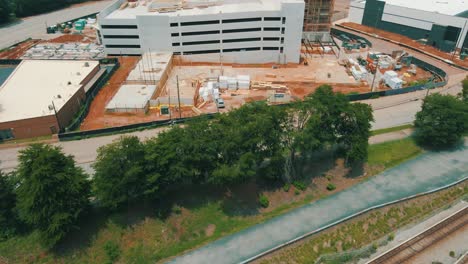 a slow reveal of an active construction site, including workers and large pieces of equipment