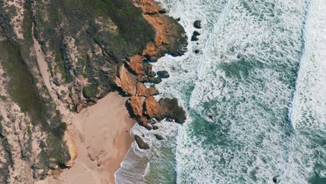 california big sur sandy beach slow motion at highway one, famous road trip route bird view aerial