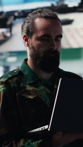 vertical video officer monitoring real time combat data using advanced military systems