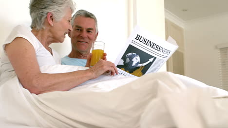 senior couple reading newspaper