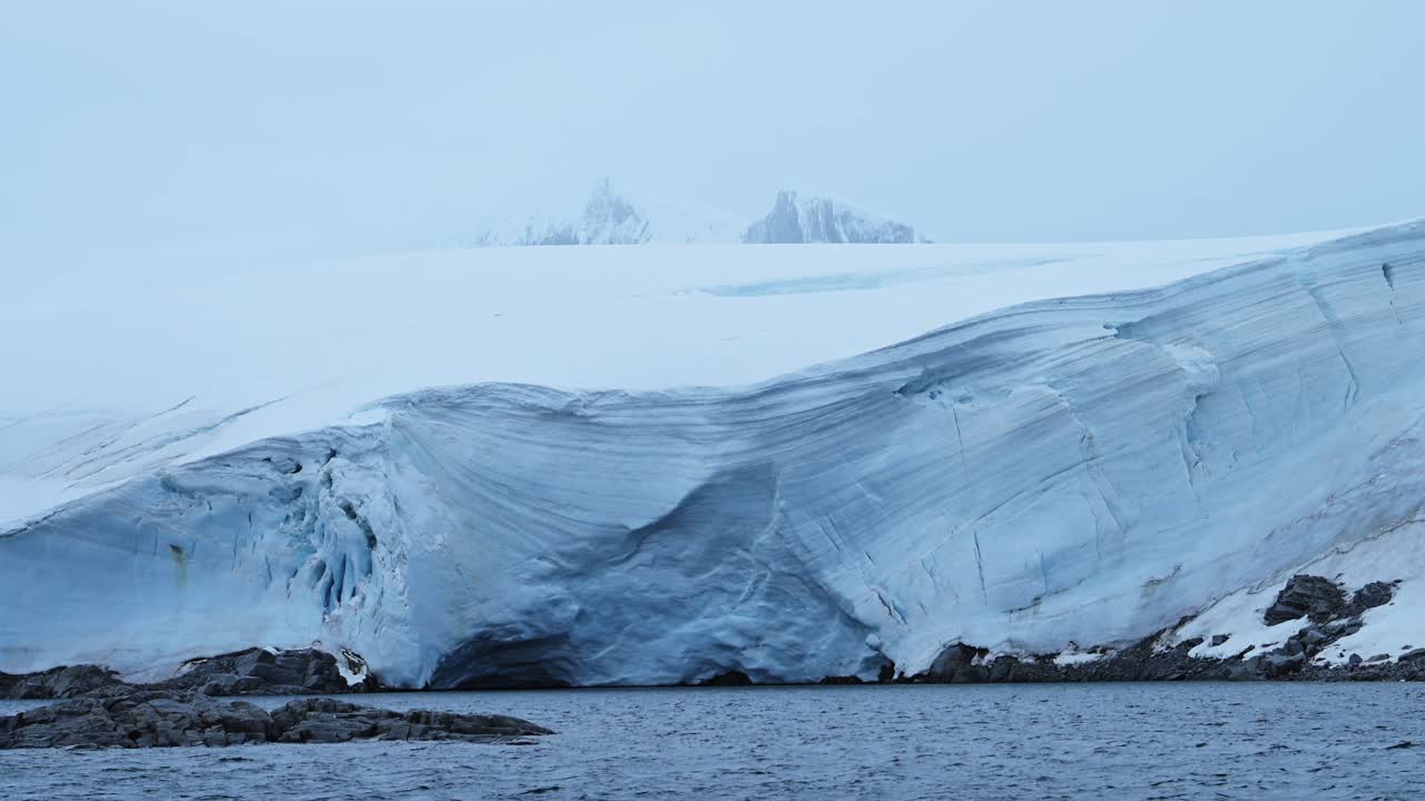 Massive Glacier Front and Icy Mountains in Antarctica
