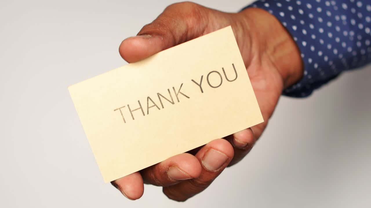Hand Holding a Thank You Card