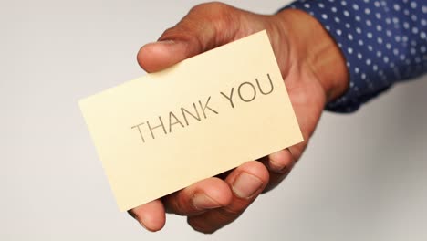 hand holding a thank you card