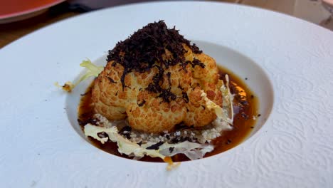 fine dining truffle cauliflower in a michelin restaurant, luxury fancy food, beautiful presentation, 4k shot