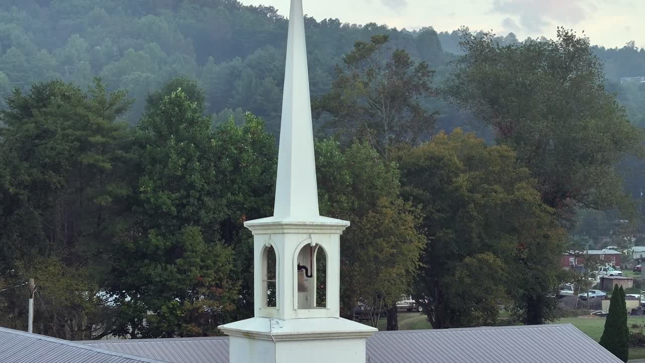 Church along side of a hill on a foggy morning in Marble NC drone view in 4K