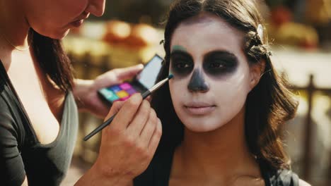 applying day of the dead skull makeup