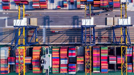 top view time lapse unloading goods from the ship in industrial port with container port where is a part of shipping