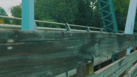 a reveal of cars passing over a bridge sitting above a steady river